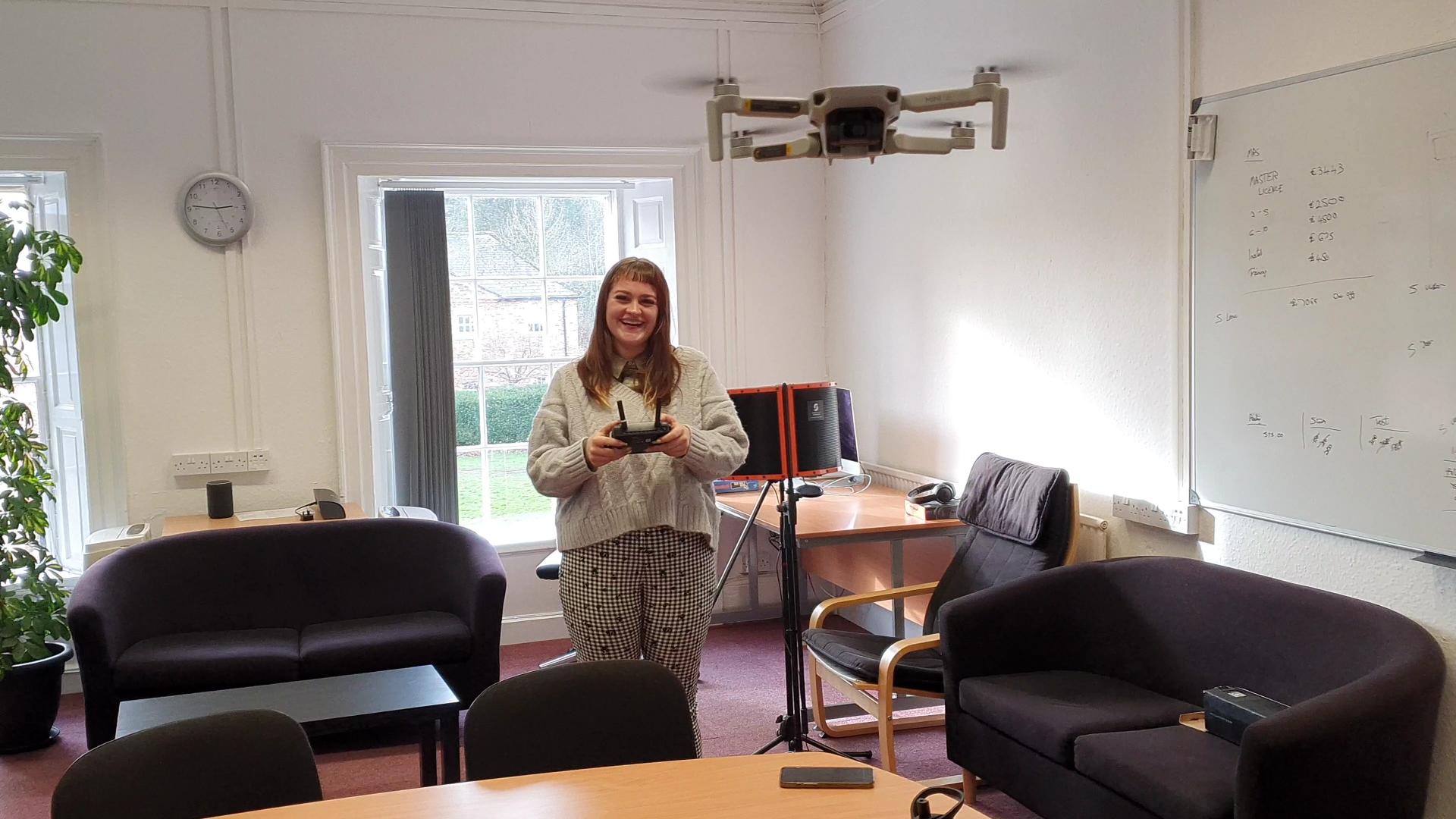 Bee flying a drone in the WJPS office